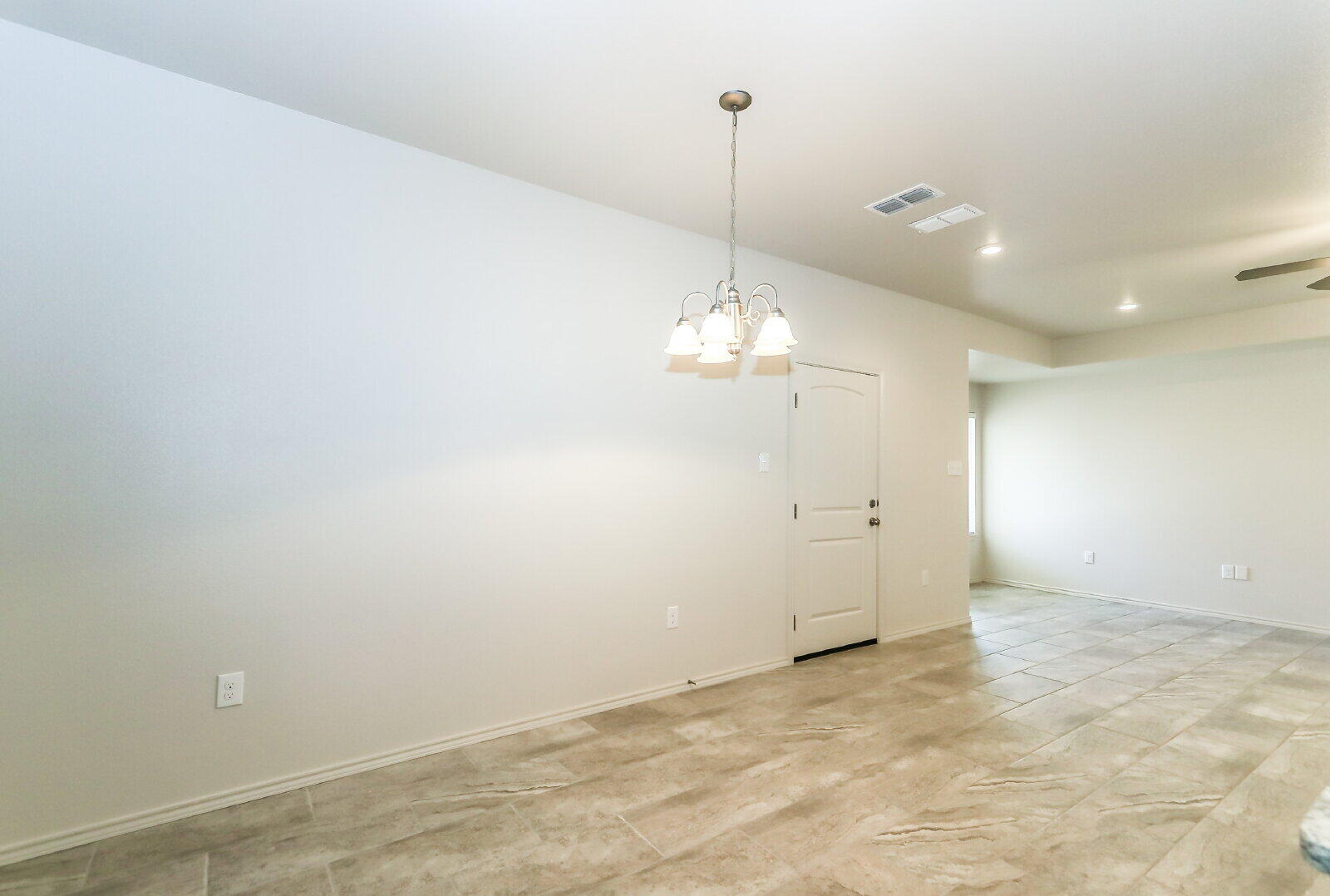 6903 67th Street, Unit A Lubbock, TX 79424 - Photo 15 of 32 a view of an empty room and a kitchen