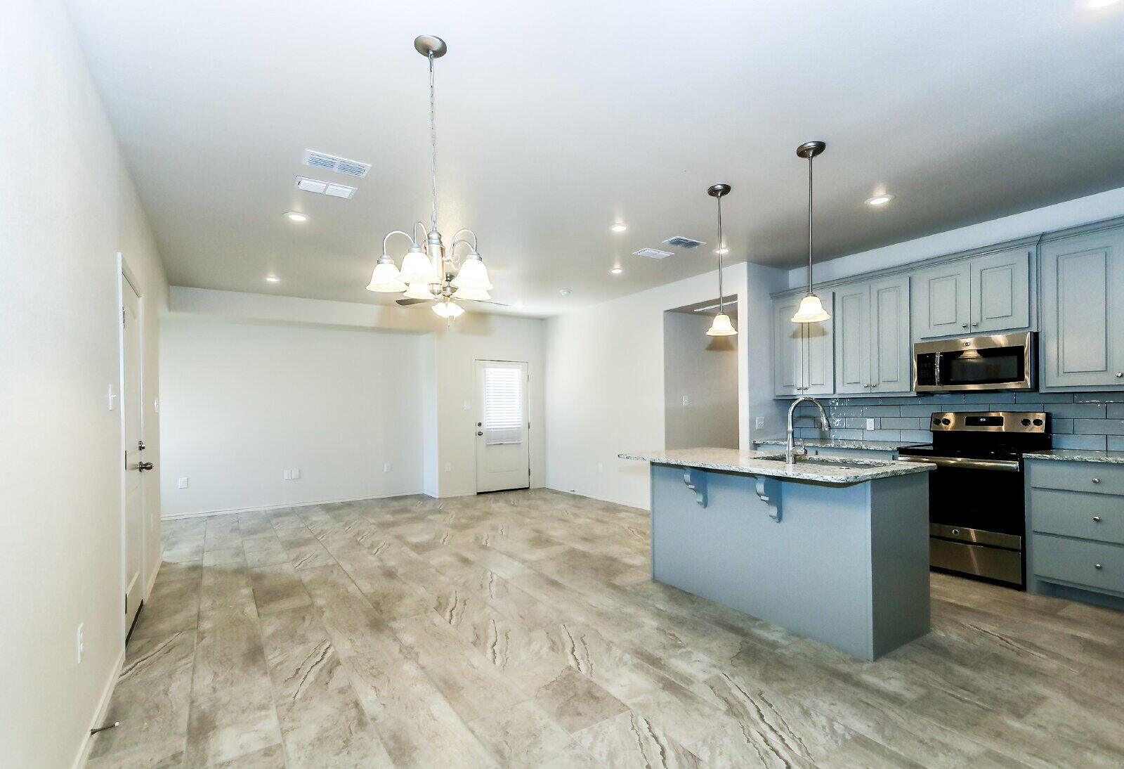 6903 67th Street, Unit A Lubbock, TX 79424 - Photo 17 of 32 a view of a kitchen with granite countertop stainless steel appliances and a sink