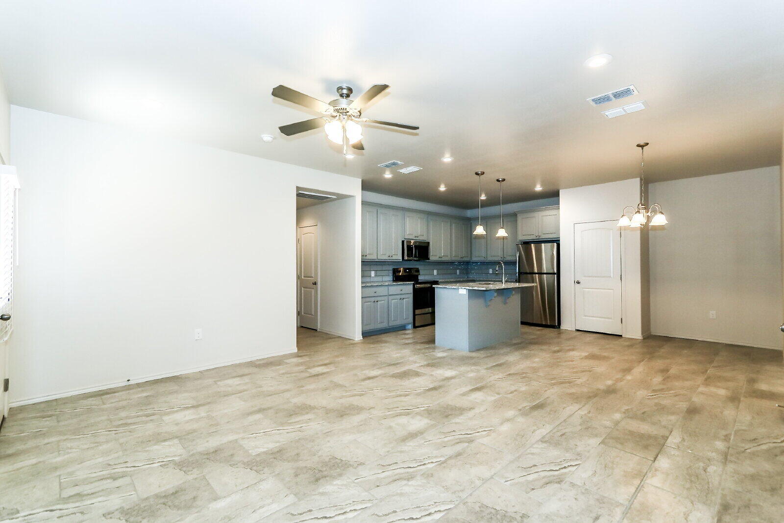 6903 67th Street, Unit A Lubbock, TX 79424 - Photo 2 of 32 a view of a kitchen with a sink and stainless steel appliances