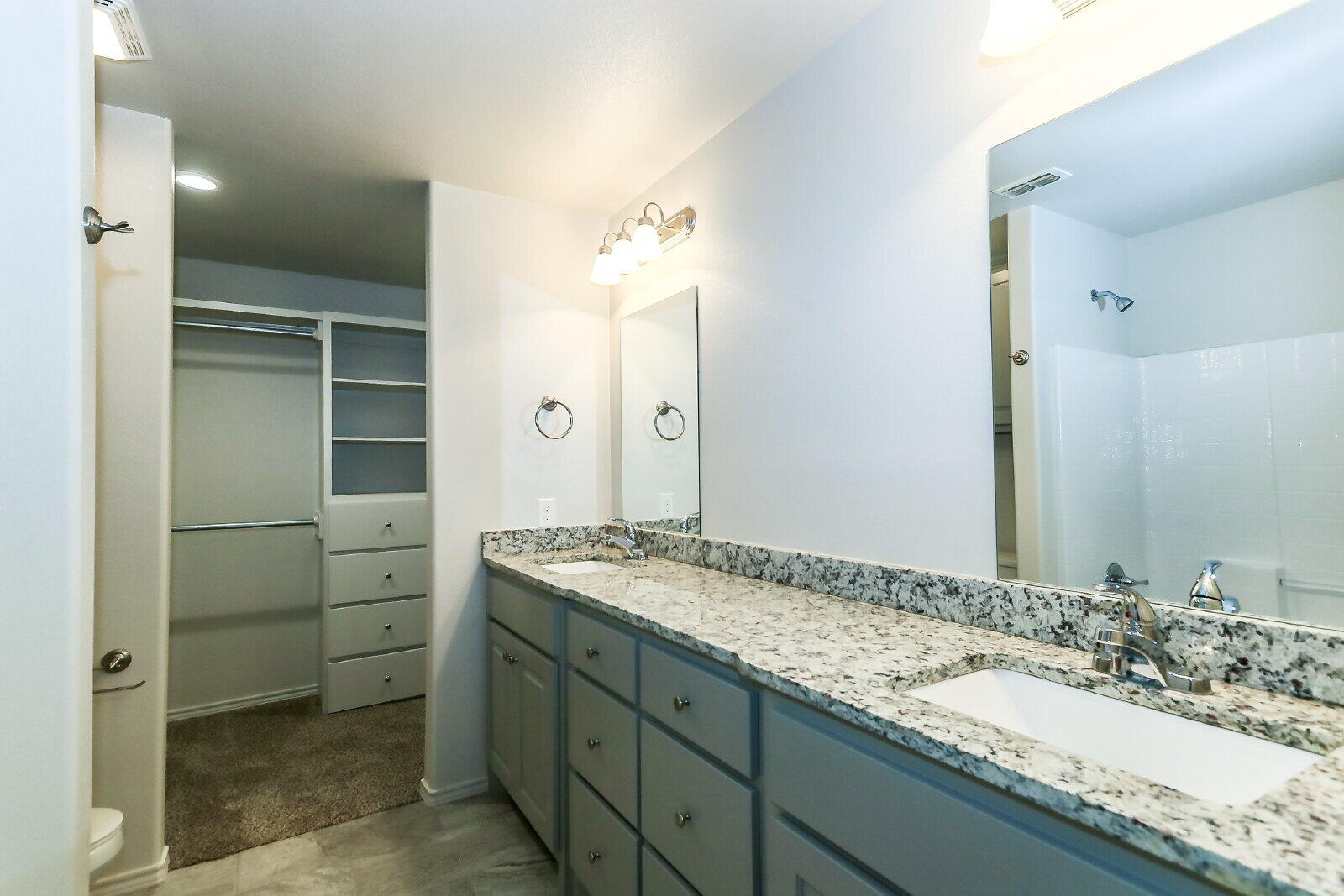 6903 67th Street, Unit A Lubbock, TX 79424 - Photo 21 of 32 a bathroom with a granite countertop sink and a mirror