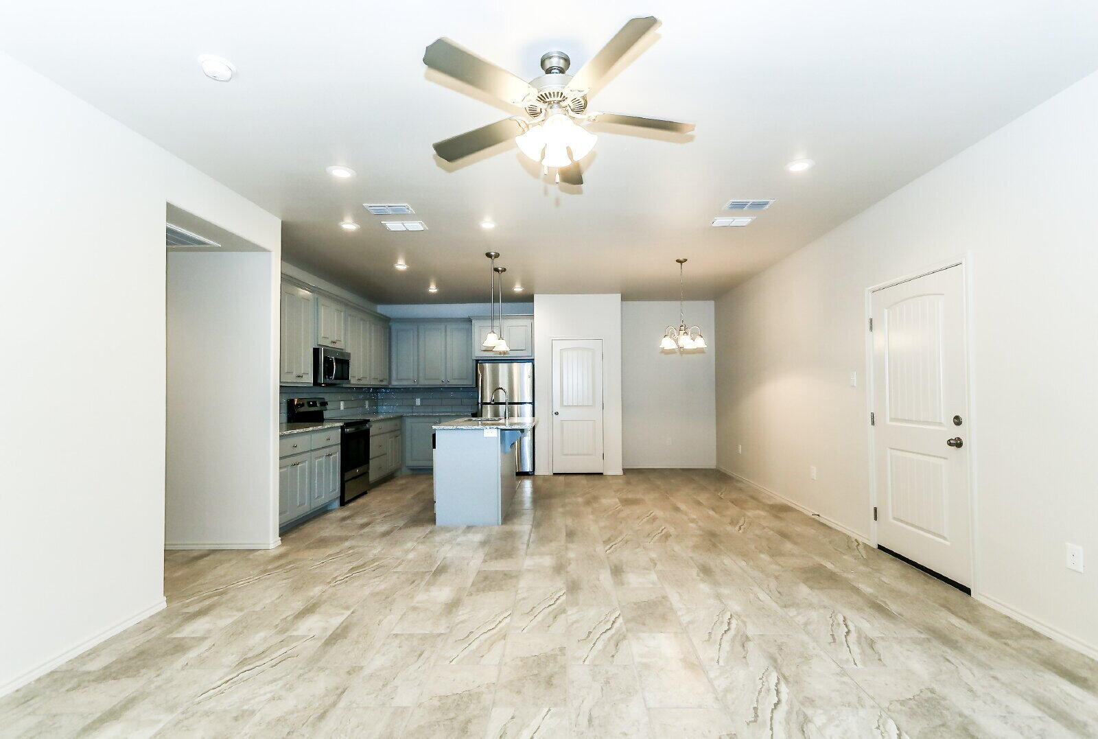 6903 67th Street, Unit A Lubbock, TX 79424 - Photo 3 of 32 a view of kitchen with sink refrigerator and cabinets