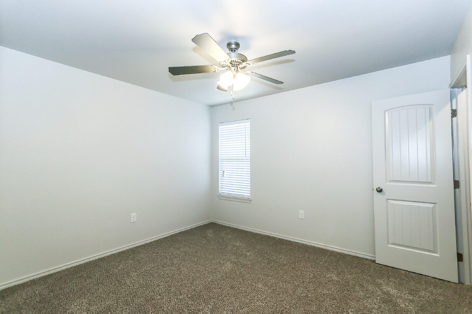 6903 67th Street, Unit A Lubbock, TX 79424 - Photo 31 of 32 an empty room with a window and a fan