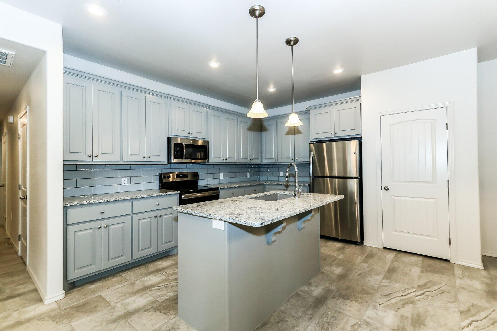 6903 67th Street, Unit A Lubbock, TX 79424 - Photo 8 of 32 a kitchen with stainless steel appliances granite countertop a sink stove and refrigerator