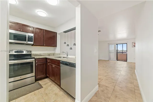 a kitchen with stainless steel appliances granite countertop a stove and a microwave