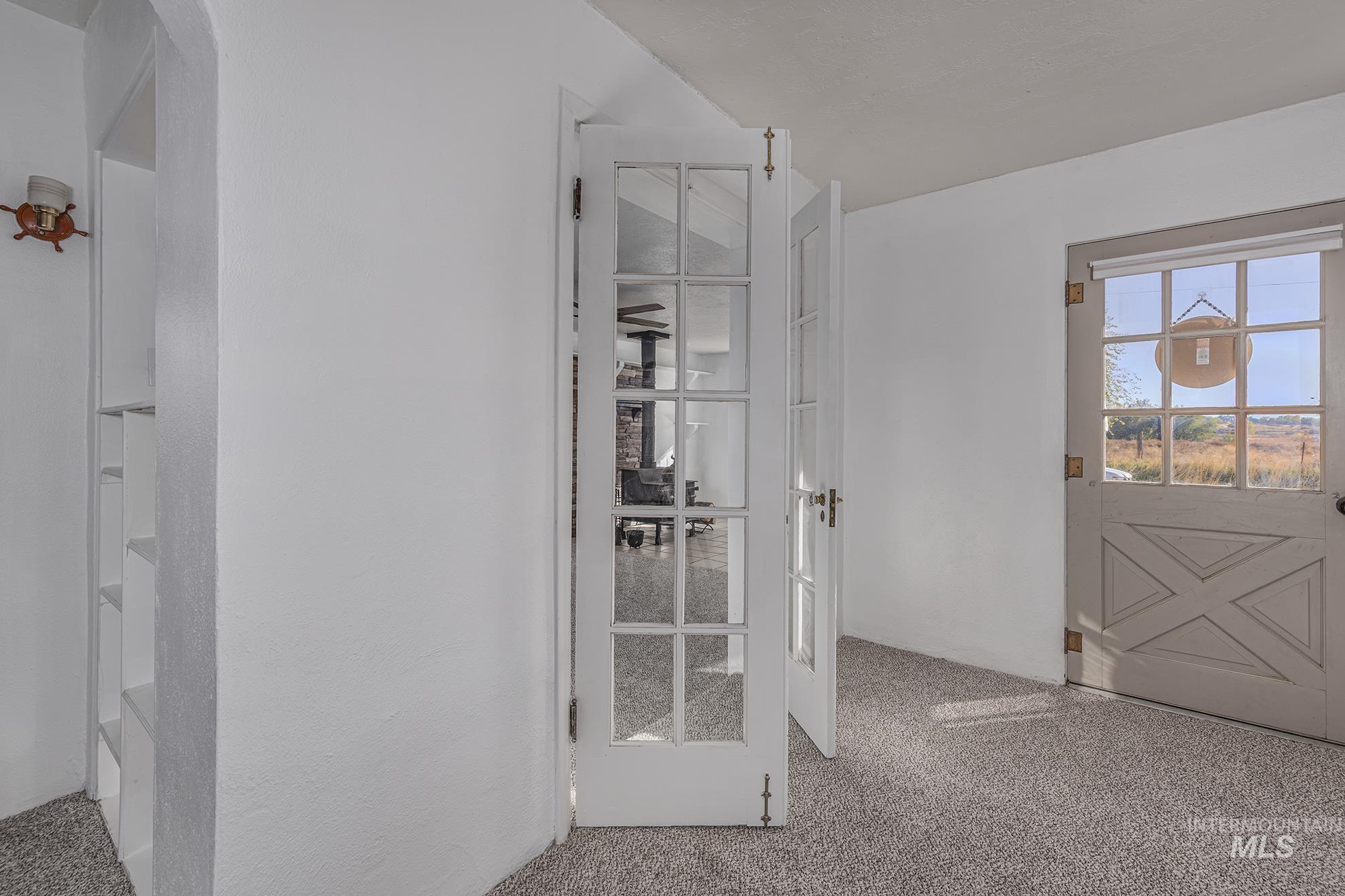 28552 Market Road Caldwell, ID 83607 - Photo 12 of 50 Doorway to outside featuring carpet