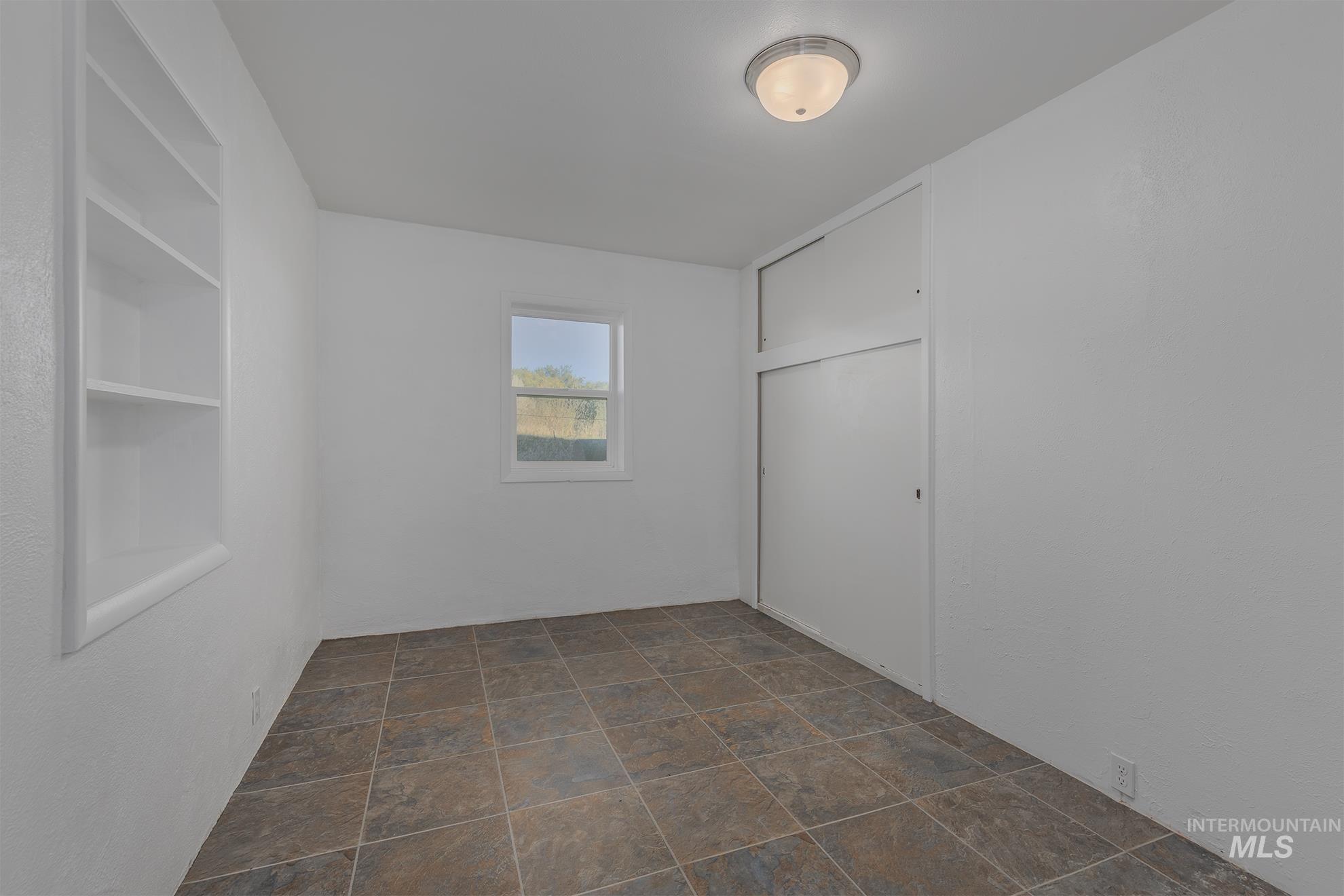 28552 Market Road Caldwell, ID 83607 - Photo 17 of 50 Unfurnished bedroom featuring a closet and stone finish flooring