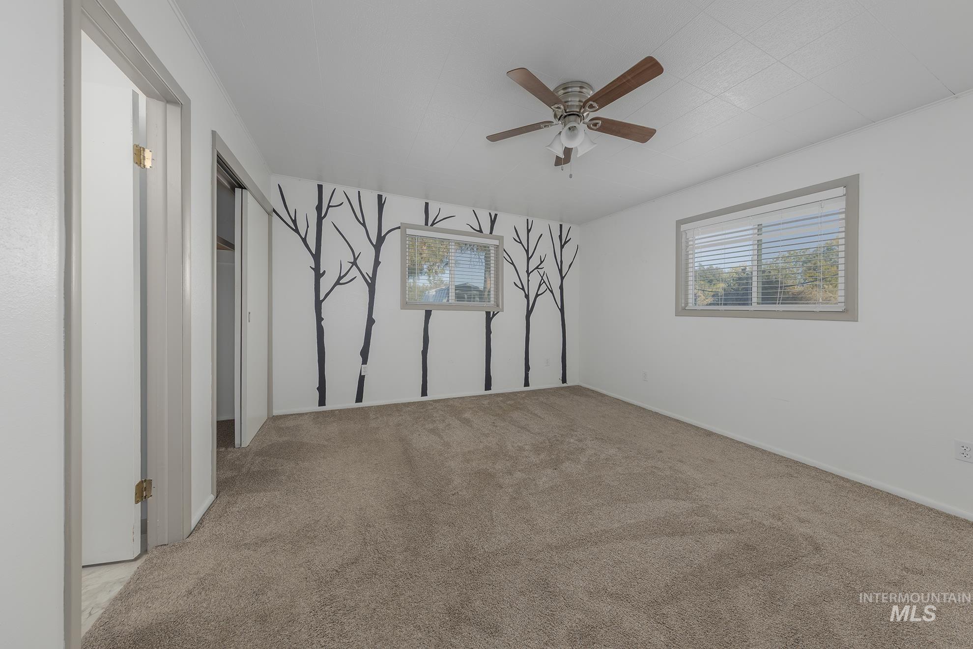 28552 Market Road Caldwell, ID 83607 - Photo 18 of 50 Spare room with light colored carpet, healthy amount of natural light, and a ceiling fan