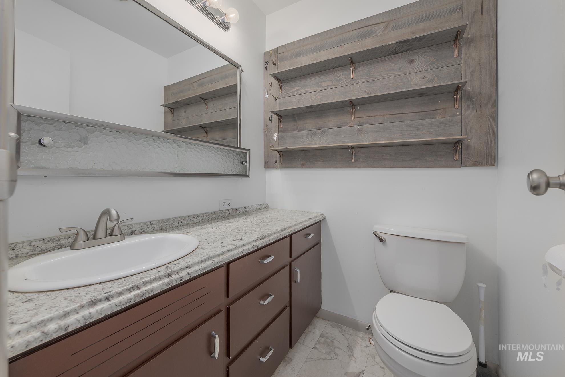 28552 Market Road Caldwell, ID 83607 - Photo 23 of 50 Half bathroom with vanity and light marble finish flooring