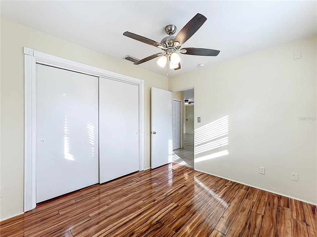 12295 Ridge Road Largo, FL 33778 - Photo 11 of 31 a view of empty room with wooden floor and fan