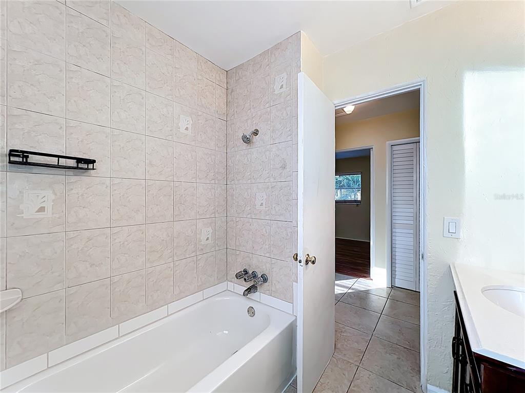 12295 Ridge Road Largo, FL 33778 - Photo 17 of 31 a bathroom with a bathtub and shower