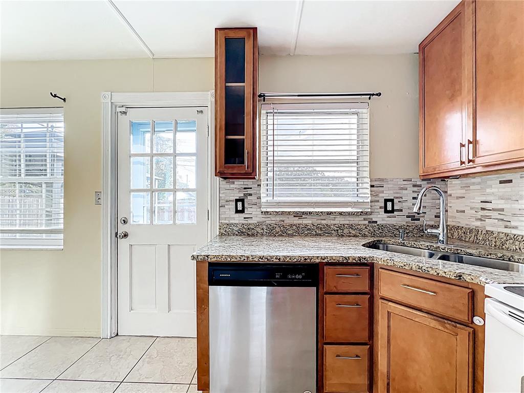 12295 Ridge Road Largo, FL 33778 - Photo 9 of 31 a kitchen with stainless steel appliances granite countertop a sink stove and cabinets