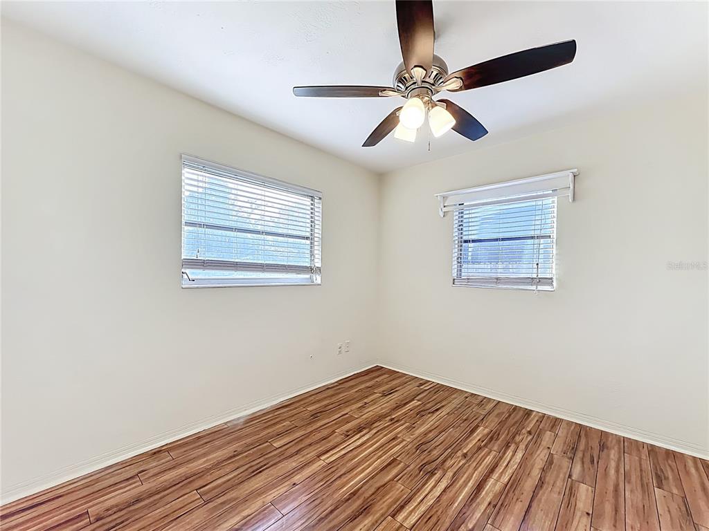 12295 Ridge Road Largo, FL 33778 - Photo 10 of 31 a view of a room with wooden floor and a ceiling fan
