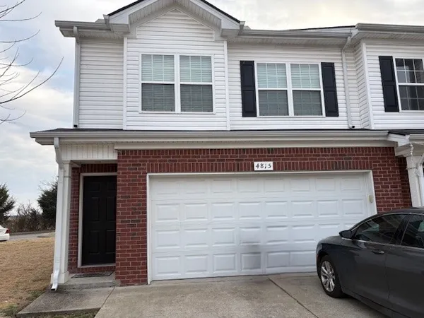 a view of a car parked in front of a house