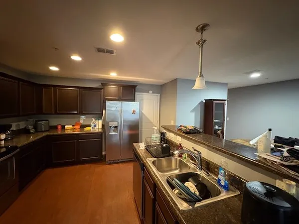 a kitchen with kitchen island a stove and a refrigerator