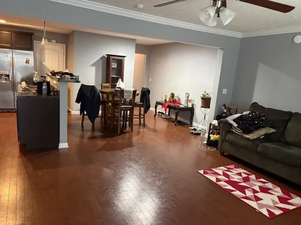 a living room with furniture and wooden floor
