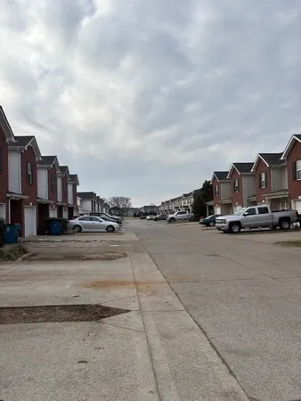 a view of a city street and a car parked on the roadside