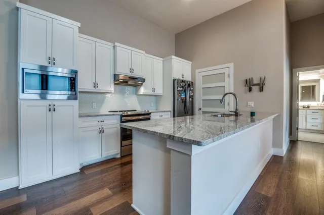 a spacious bedroom with a large bed and a large window