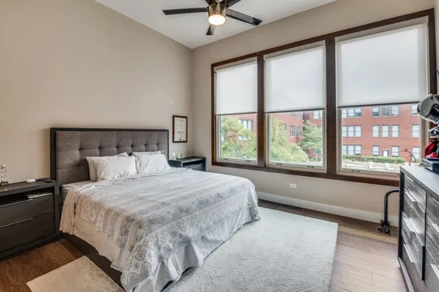 a spacious bathroom with a granite countertop sink a toilet and a mirror