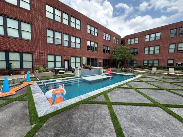 a view of a swimming pool with a lounge chairs in patio