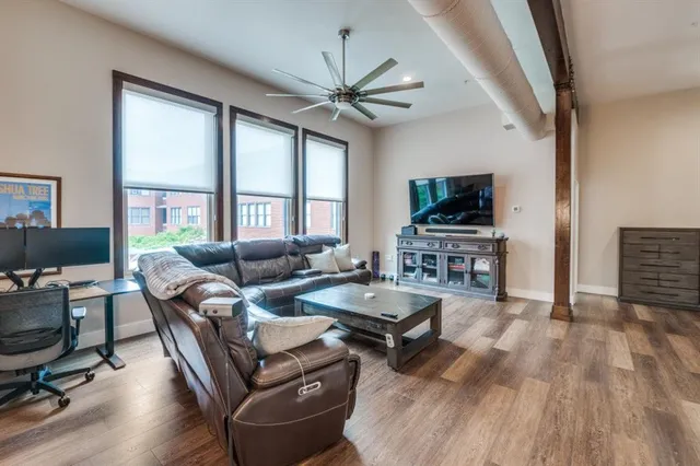 a living room with furniture and a wooden floor