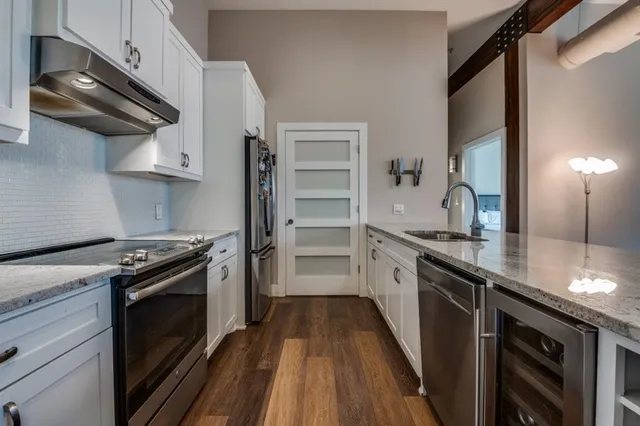 a kitchen with stainless steel appliances granite countertop a stove and a refrigerator
