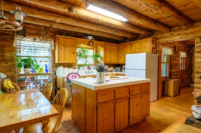a view of a kitchen with workspace and a window