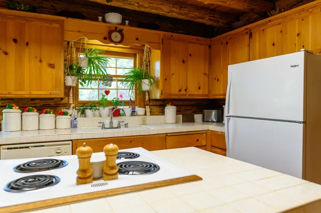 a kitchen with granite countertop a refrigerator and a sink