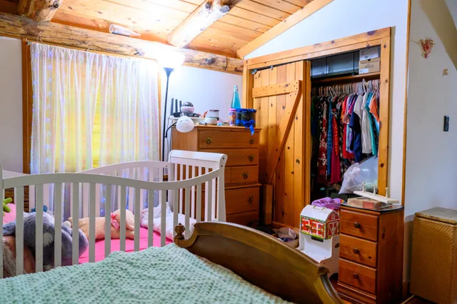 a bedroom with a bed and a window