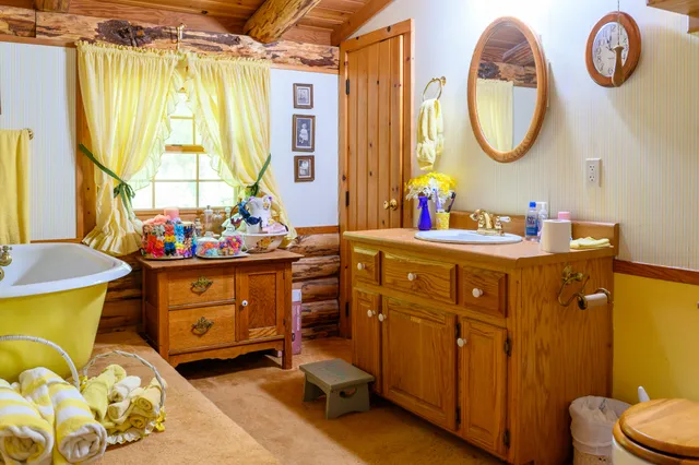 a bathroom with a sink mirror and a window