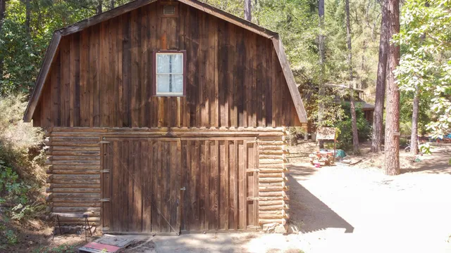a view of a house with wooden fence