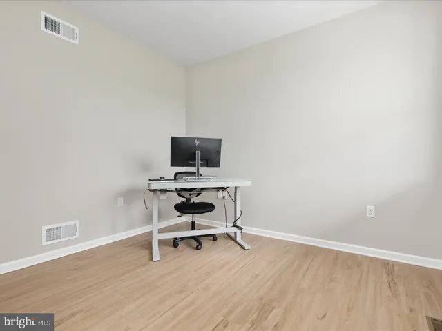a view of workspace with wooden floor and windows