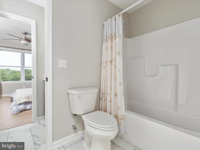 a en suite bathroom with a granite countertop sink and a mirror
