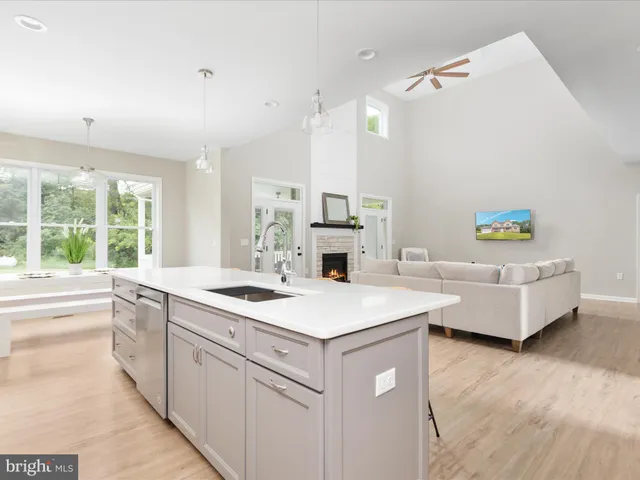 a kitchen with a sink and a stove top oven