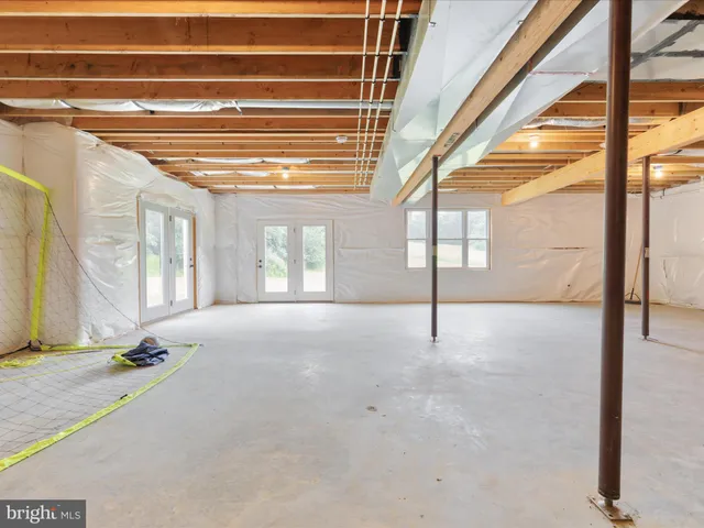 a view of a patio with couches chairs potted plants and floor to ceiling window