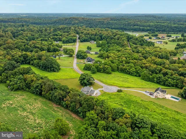 an aerial view of house with yard and lake view