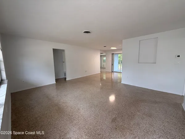 a view of kitchen with granite countertop white cabinets and a sink