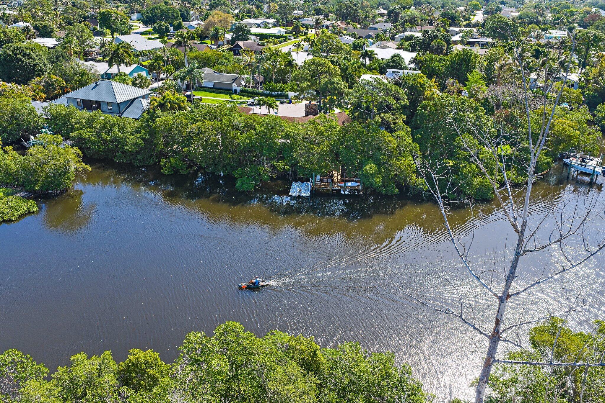 702 Warren Drive Jupiter, FL 33458 - Photo 8 of 76 an aerial view of a house with a yard and lake view