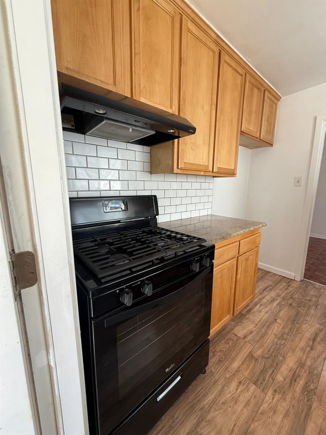 501 Rotan Avenue Madera, CA 93637 - Photo 2 of 23 a kitchen with granite countertop wooden cabinets and a stove top oven