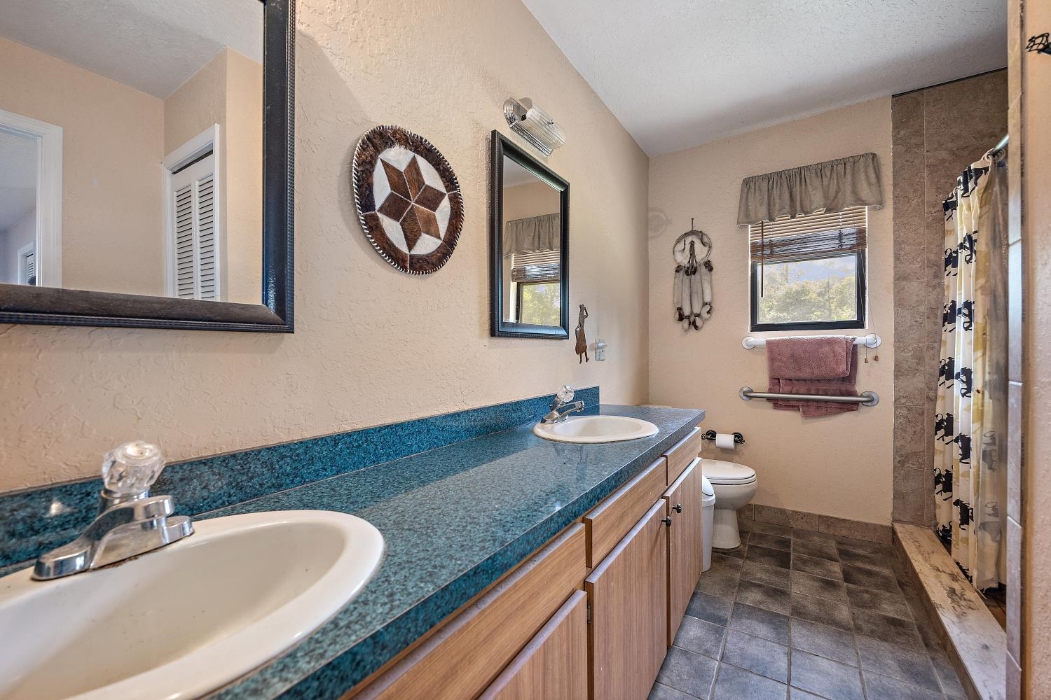 2670 Cabbage Hammock Road St. Augustine, FL 32092 - Photo 13 of 28 a bathroom with a granite countertop double vanity sink and a mirror