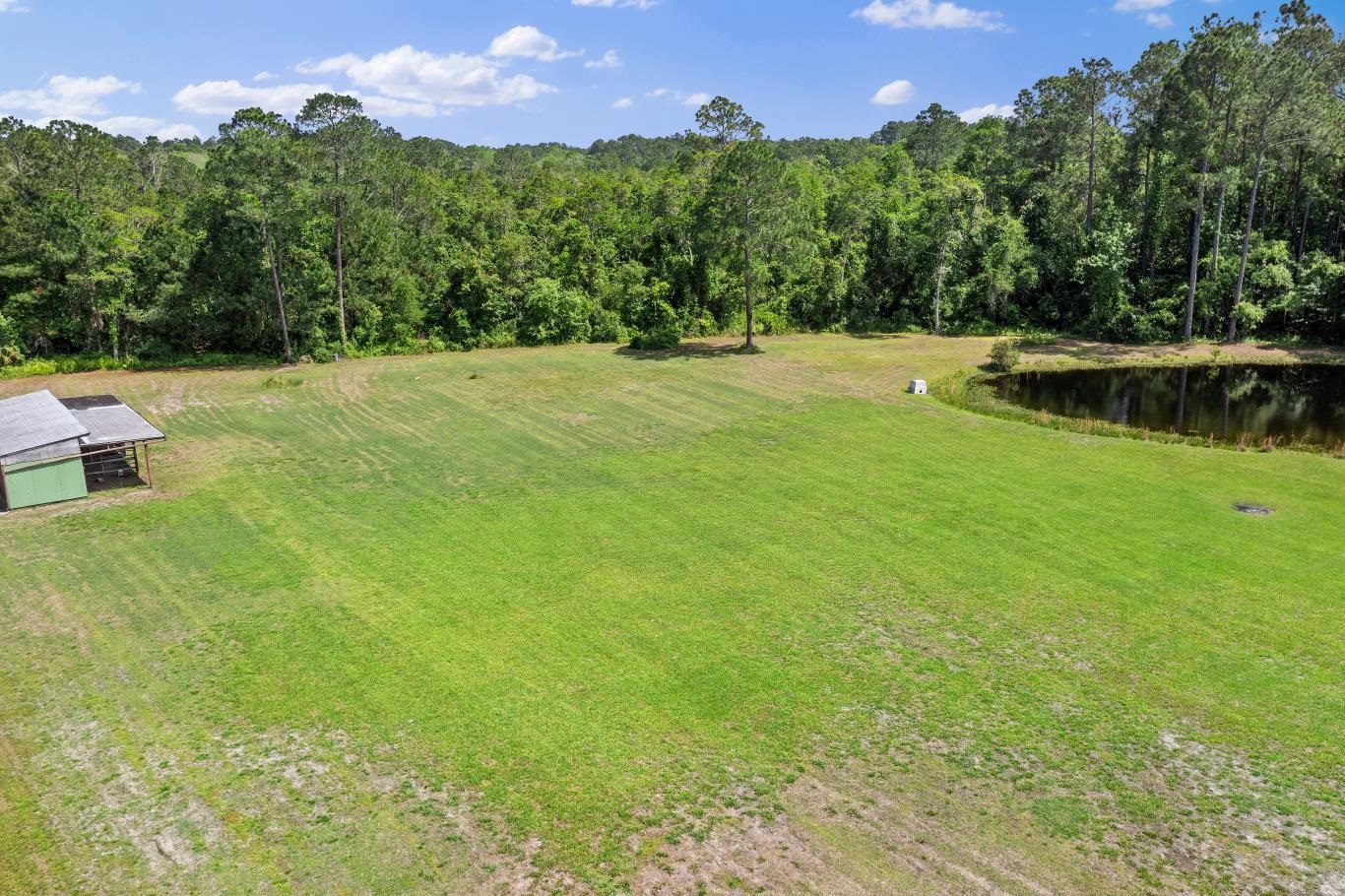 2670 Cabbage Hammock Road St. Augustine, FL 32092 - Photo 21 of 28 a view of a garden with a building in the background