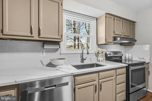 a kitchen with appliances cabinets and a sink
