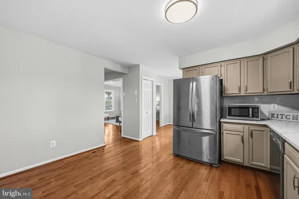 a kitchen with stainless steel appliances granite countertop a refrigerator sink and cabinets
