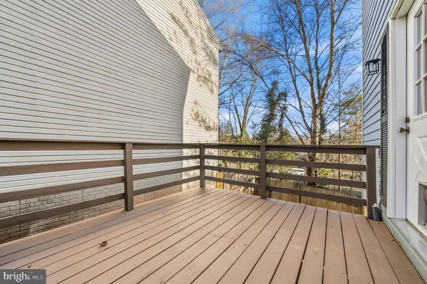 a view of balcony with wooden floor and fence
