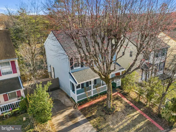a view of a house with a yard and wooden fence