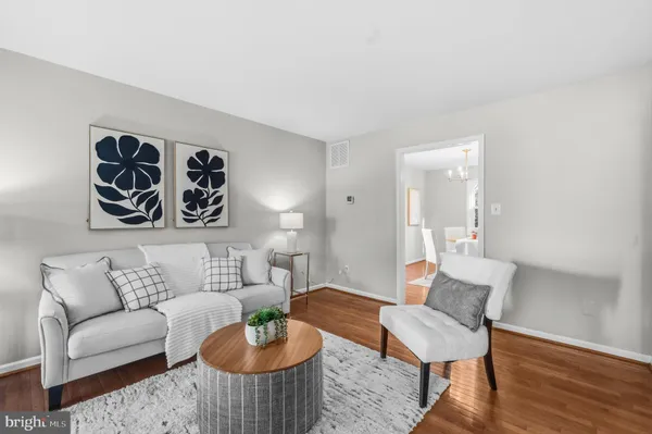 a living room with furniture and a painting