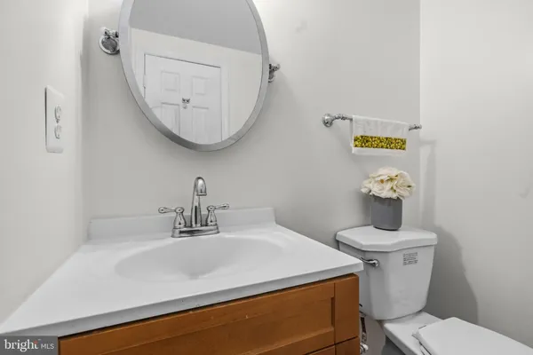 a bathroom with a sink mirror and toilet