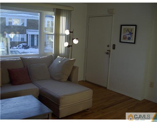 197 Evergreen Road, Unit 6A Edison, NJ 08837 - Photo 3 of 12 a living room with furniture and a gate