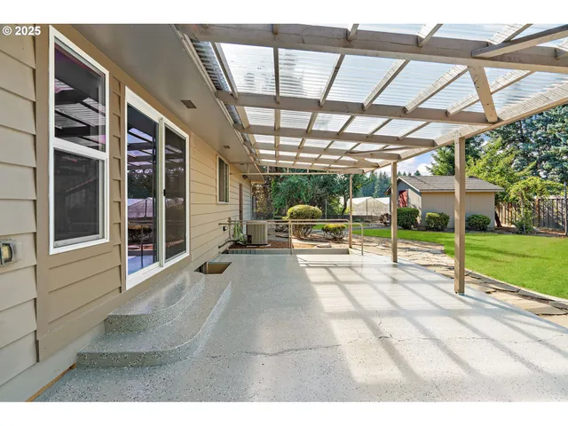 a view of a porch with furniture and a yard