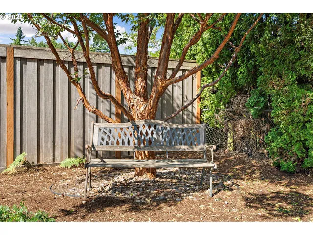 a sign board with wooden fence
