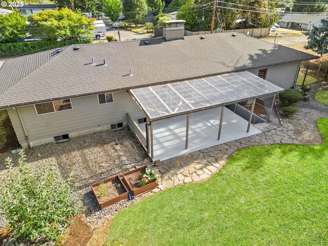 an aerial view of a house with swimming pool garden and patio